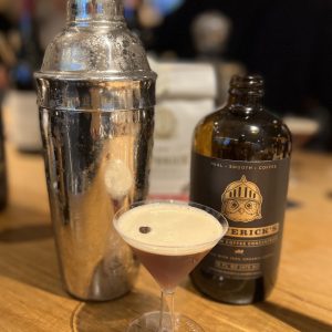 Espresso Martini on a bar with shaker and Cold Brew Concentrate Bottle