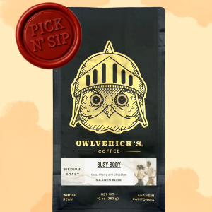 Front of Black Coffee Bag with Owl Design named Busy Body. Red stamp says "Pick N' Sip" to designate that this is for a pickup only product. Pickup is September 11, 2026 between 9am and 12pm.